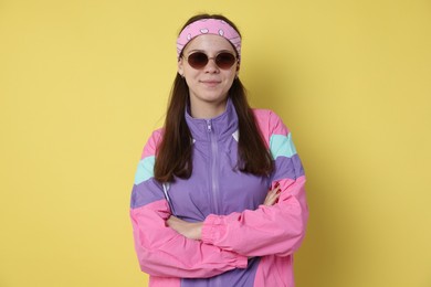 Photo of Teenage girl in sunglasses on yellow background
