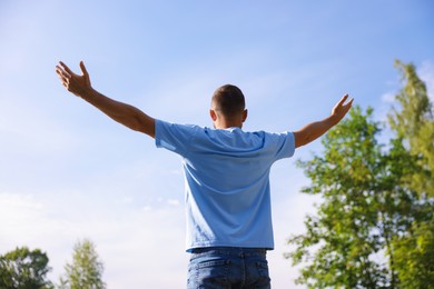 Photo of Feeling freedom. Man enjoying time outdoors, back view