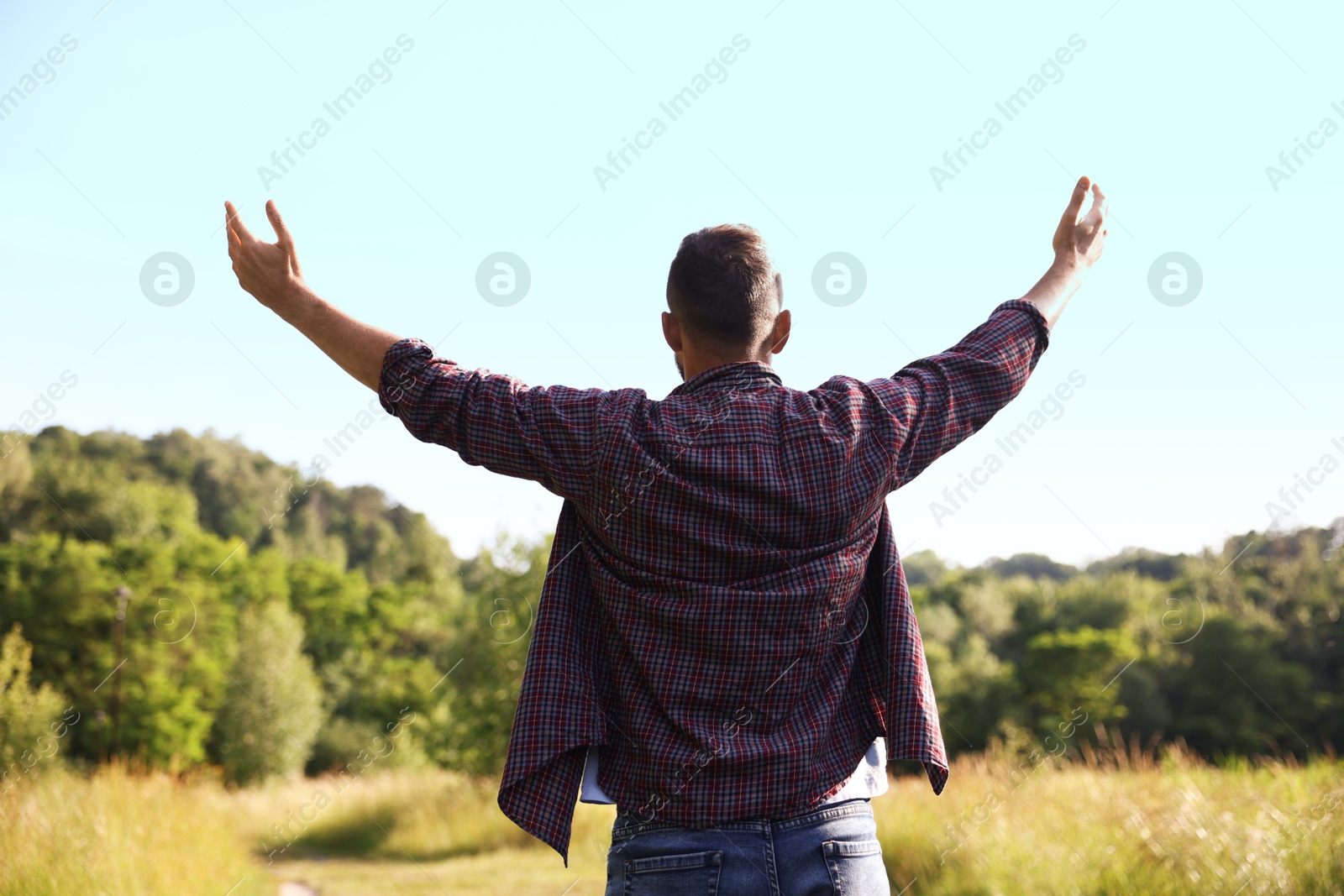Photo of Feeling freedom. Man enjoying time outdoors, back view