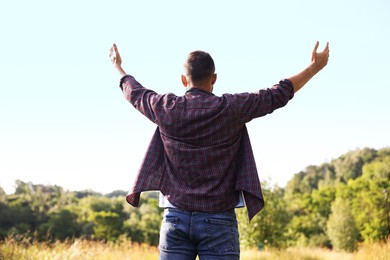 Photo of Feeling freedom. Man enjoying time outdoors, back view