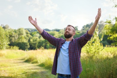 Photo of Feeling freedom. Man enjoying time outdoors. Space for text