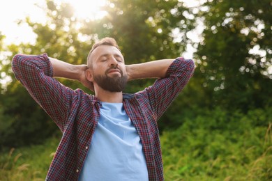 Photo of Feeling freedom. Man enjoying time outdoors. Space for text