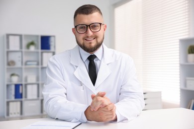 Photo of Portrait of doctor in uniform at table indoors