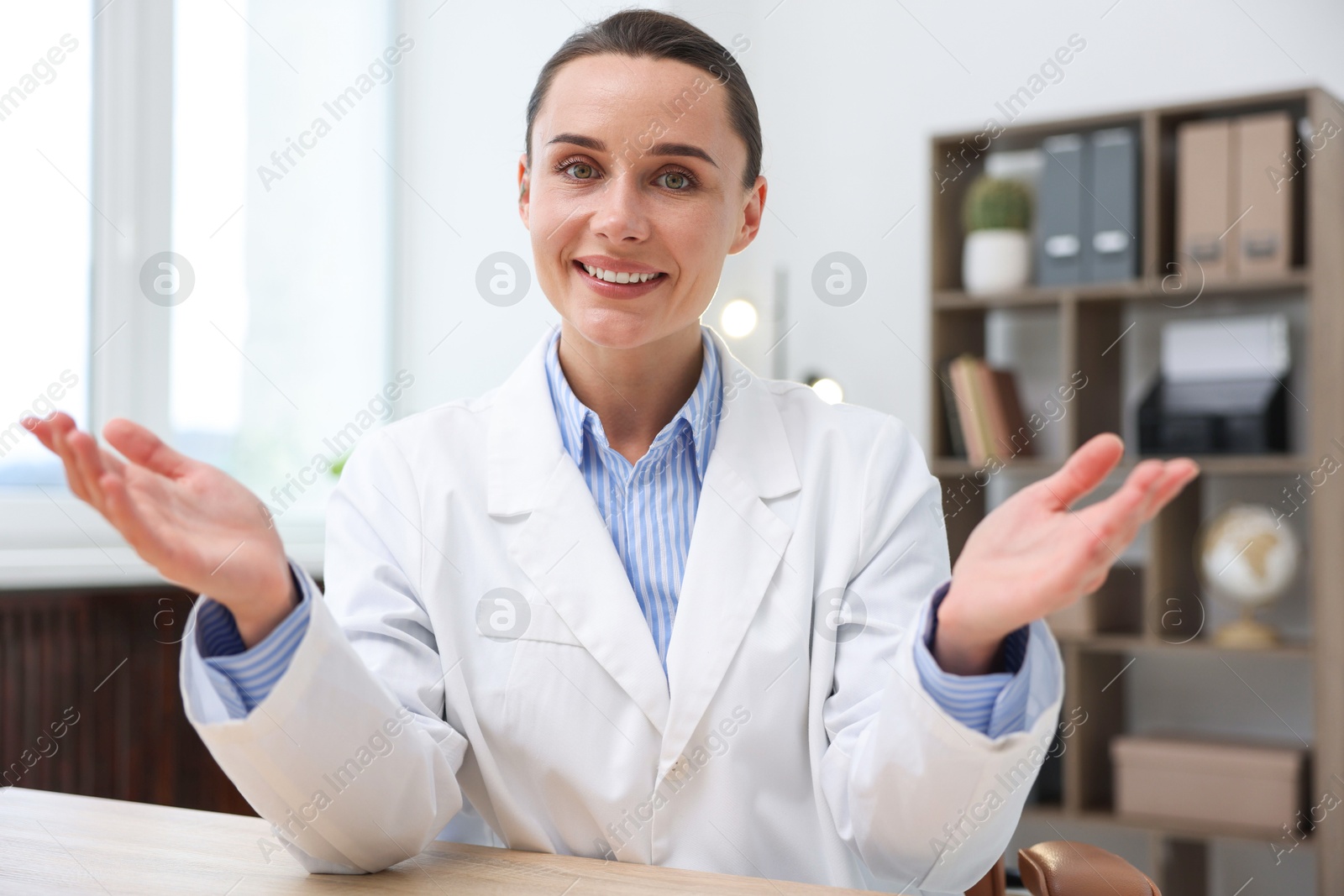 Portrait of happy doctor in uniform at table indoors Photo of Portrait of happy doctor in uniform at table indoors