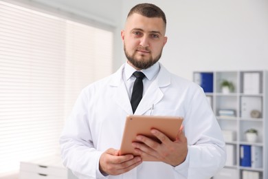Photo of Doctor with tablet in clinic. Online medical consultation