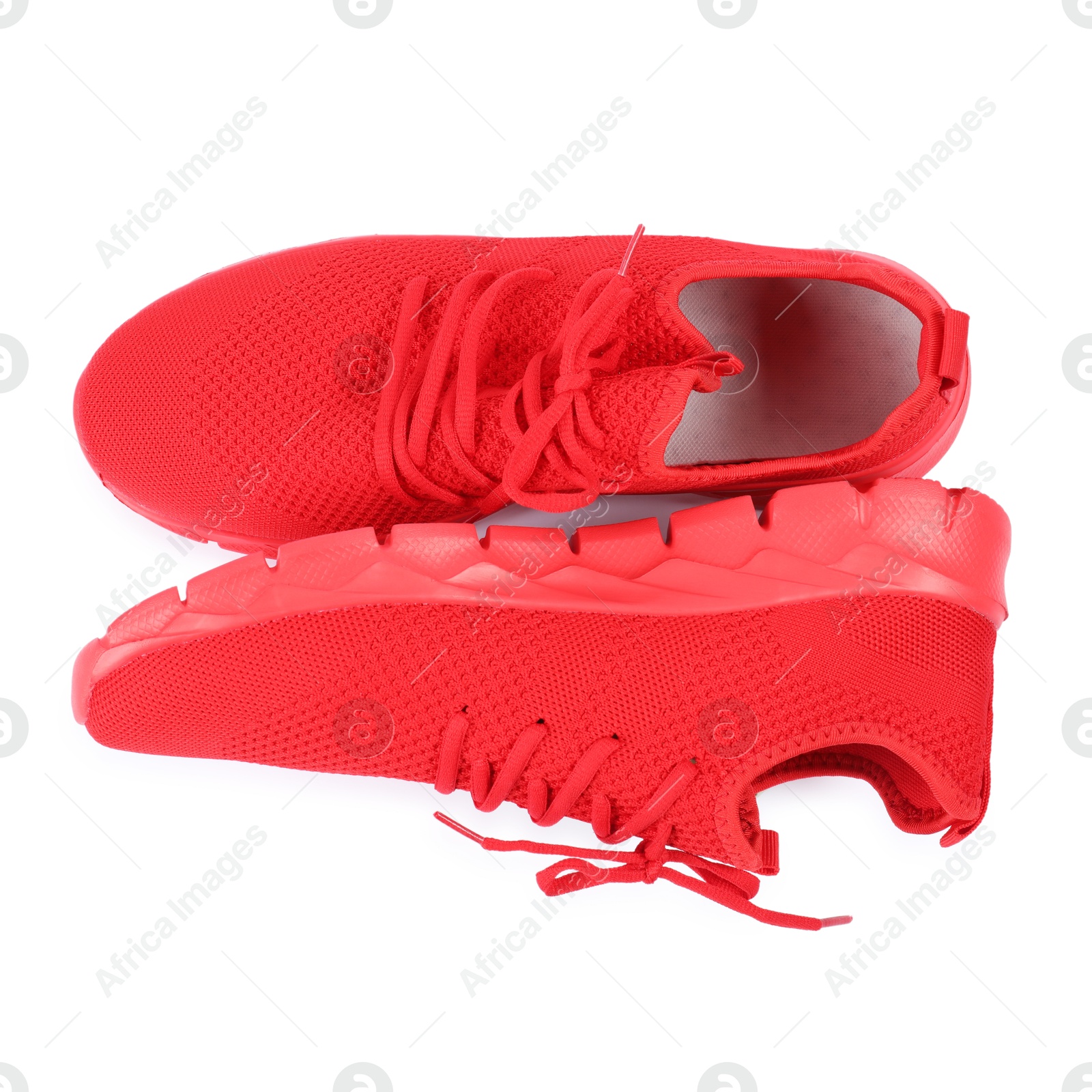 Photo of Pair of stylish red sneakers on white background, top view