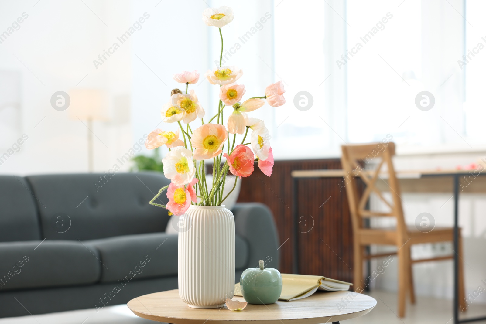 Beautiful poppy flowers and decor on table at home Photo of Beautiful poppy flowers and decor on table at home
