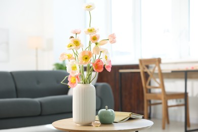 Photo of Beautiful poppy flowers and decor on table at home