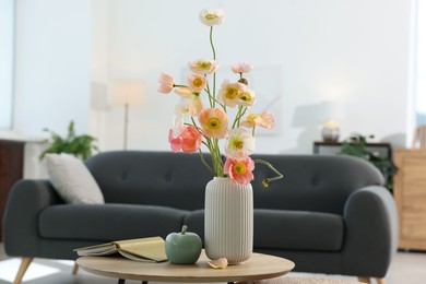 Photo of Beautiful poppy flowers and decor on table at home