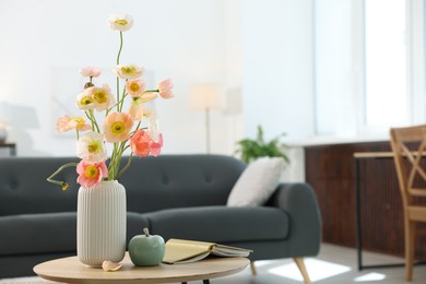 Photo of Beautiful poppy flowers and decor on table at home. Space for text