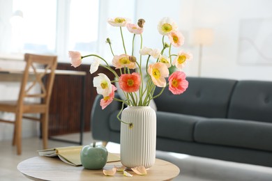 Photo of Beautiful poppy flowers and decor on table at home