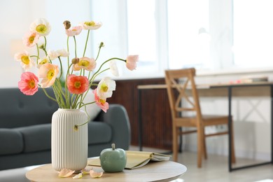 Photo of Beautiful poppy flowers and decor on table at home. Space for text