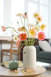 Photo of Beautiful poppy flowers and decor on table at home