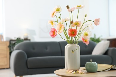 Photo of Beautiful poppy flowers and decor on table at home. Space for text