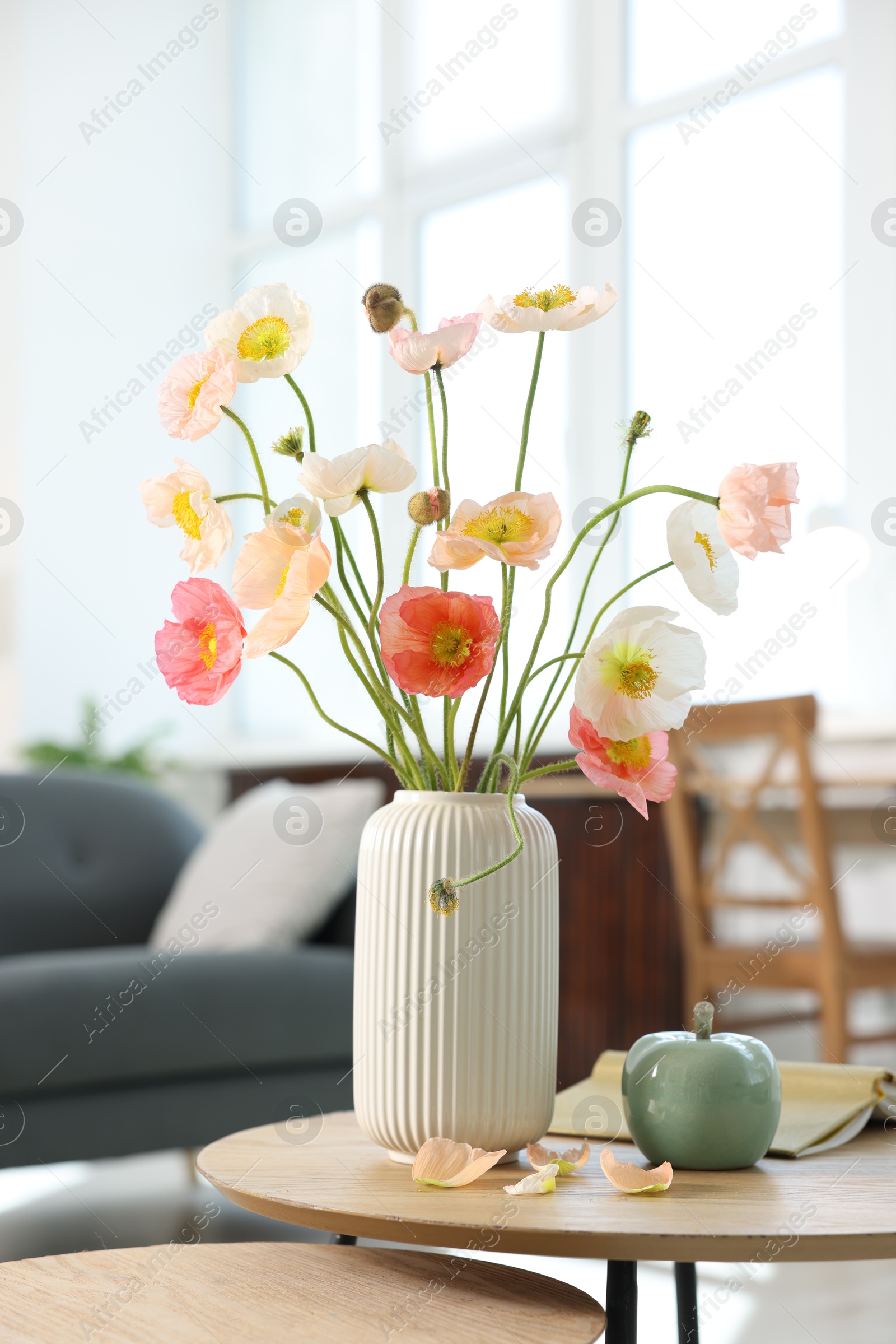 Beautiful poppy flowers and decor on table at home Photo of Beautiful poppy flowers and decor on table at home
