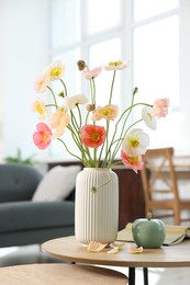 Photo of Beautiful poppy flowers and decor on table at home