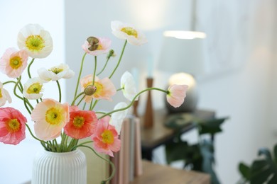 Photo of Beautiful poppy flowers in vase indoors, closeup. Space for text