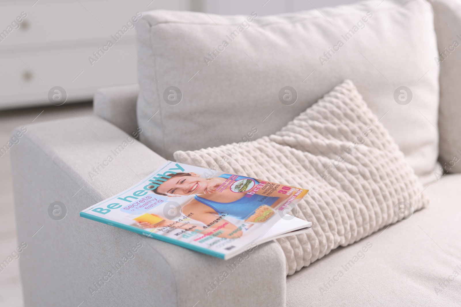One trendy magazine on sofa indoors, closeup Photo of One trendy magazine on sofa indoors, closeup