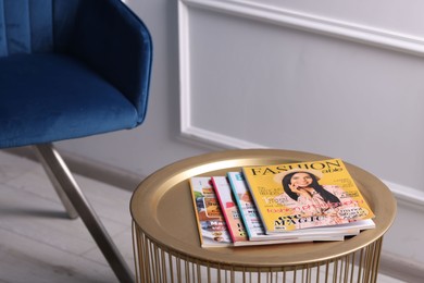 Photo of Many different trendy magazines on table indoors, closeup