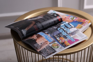 Photo of Different trendy magazines on table indoors, closeup