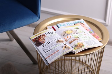 Photo of Different trendy magazines on table indoors, closeup