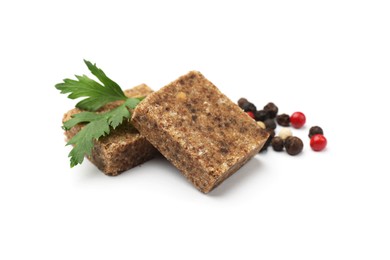 Photo of Aromatic bouillon cubes, parsley and peppercorns isolated on white