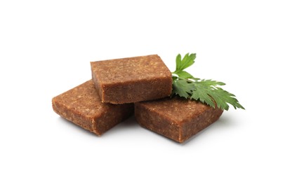 Photo of Aromatic bouillon cubes and parsley isolated on white