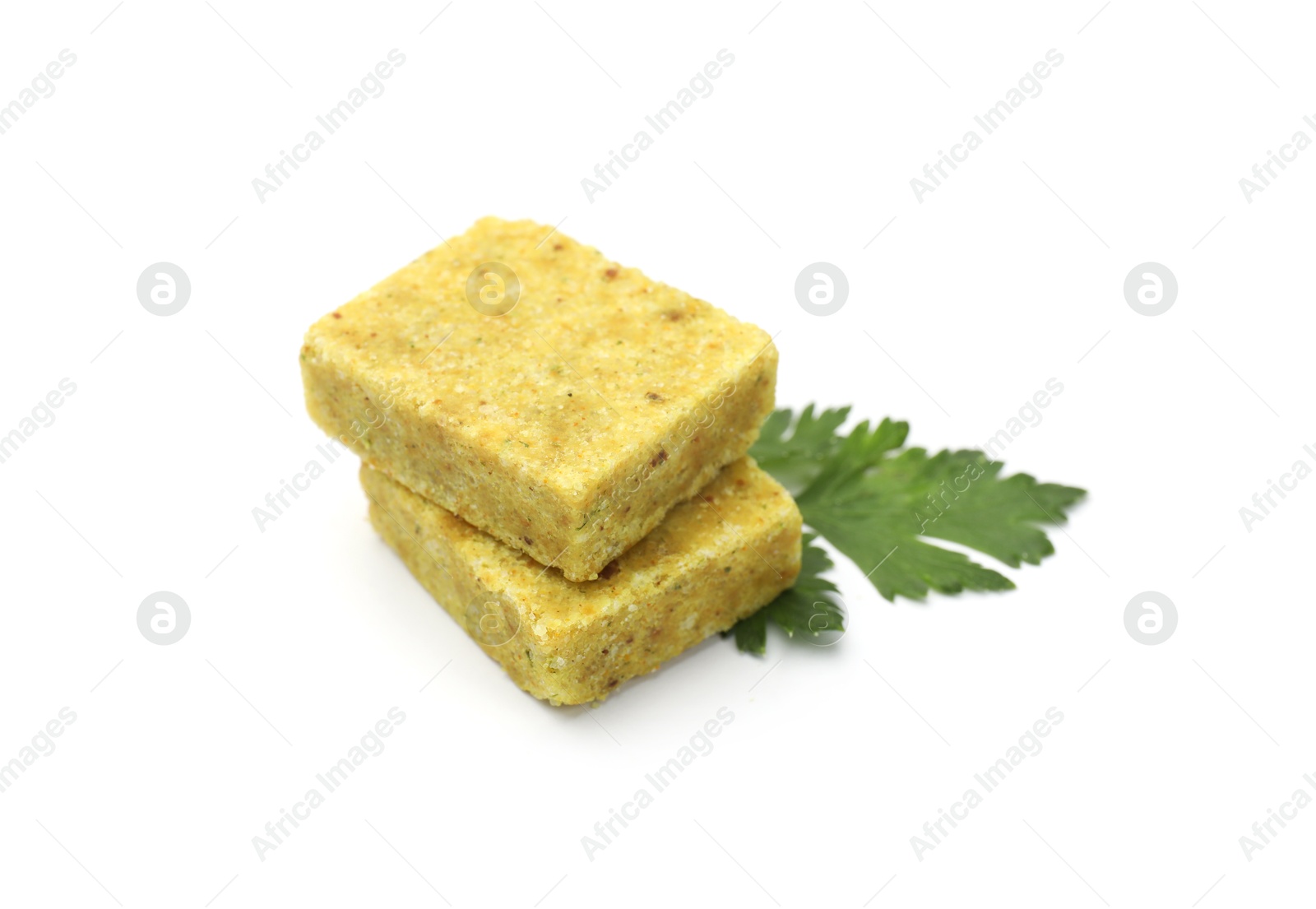 Aromatic bouillon cubes and parsley isolated on white Photo of Aromatic bouillon cubes and parsley isolated on white