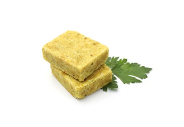 Photo of Aromatic bouillon cubes and parsley isolated on white