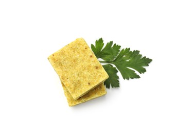 Photo of Aromatic bouillon cubes and parsley isolated on white, top view