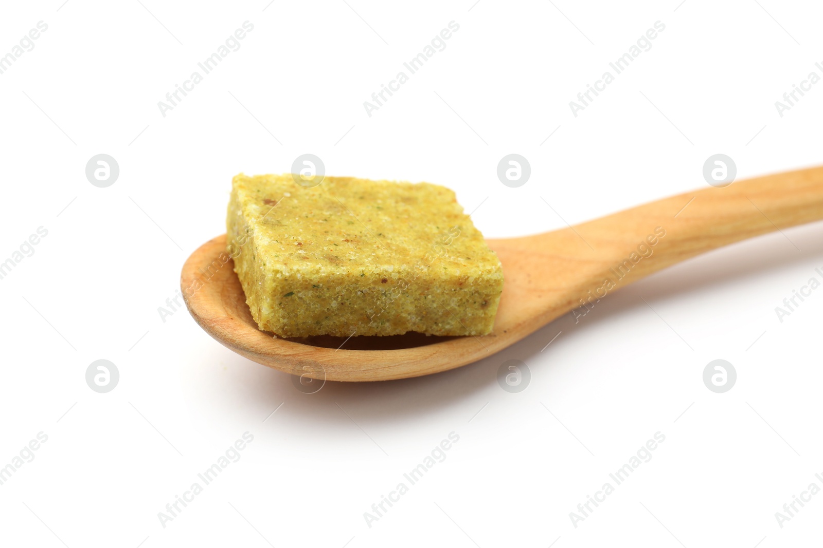Aromatic bouillon cube and wooden spoon isolated on white Photo of Aromatic bouillon cube and wooden spoon isolated on white