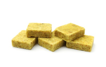 Photo of Many aromatic bouillon cubes isolated on white