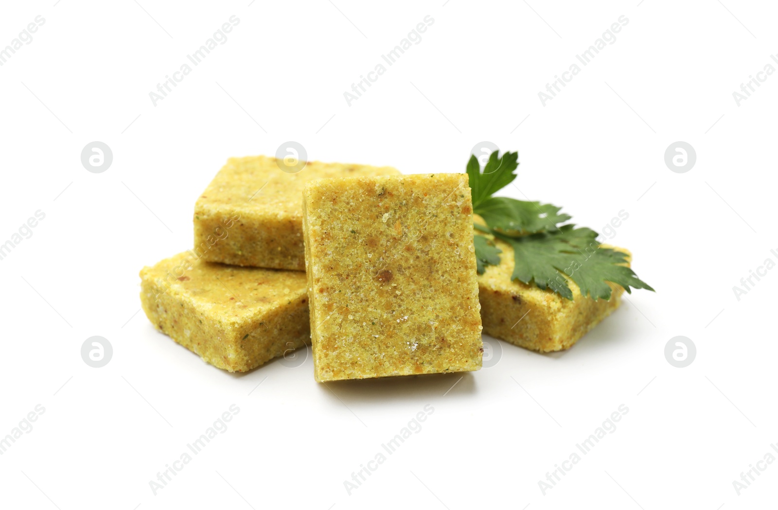 Aromatic bouillon cubes and parsley isolated on white Photo of Aromatic bouillon cubes and parsley isolated on white