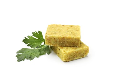 Photo of Aromatic bouillon cubes and parsley isolated on white