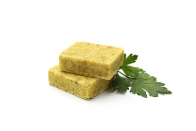 Photo of Aromatic bouillon cubes and parsley isolated on white