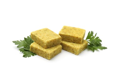 Photo of Aromatic bouillon cubes and parsley isolated on white
