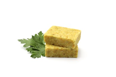 Photo of Aromatic bouillon cubes and parsley isolated on white