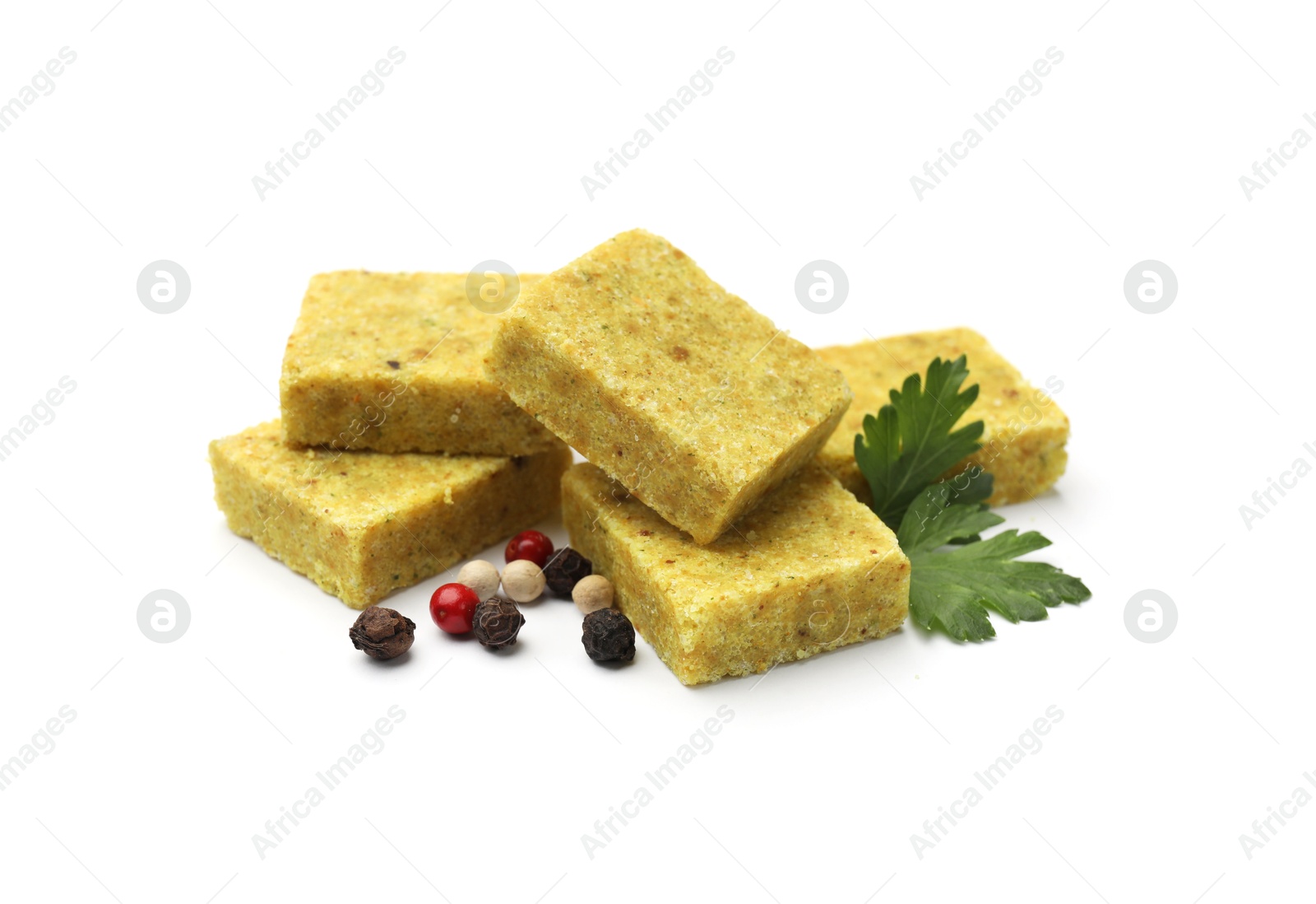 Aromatic bouillon cubes, parsley and peppercorns isolated on white Photo of Aromatic bouillon cubes, parsley and peppercorns isolated on white