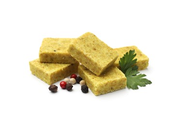 Photo of Aromatic bouillon cubes, parsley and peppercorns isolated on white