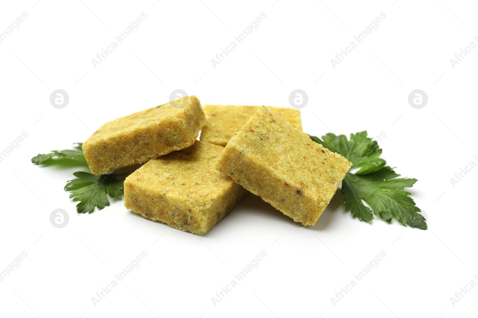 Photo of Aromatic bouillon cubes and parsley isolated on white