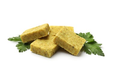 Photo of Aromatic bouillon cubes and parsley isolated on white