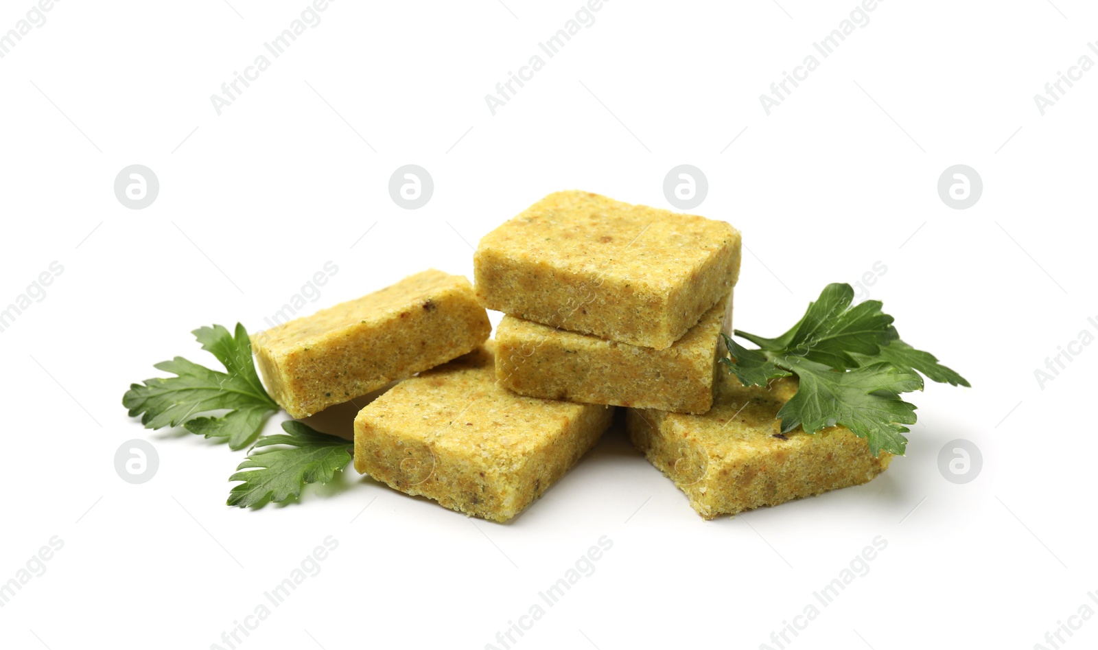Aromatic bouillon cubes and parsley isolated on white Photo of Aromatic bouillon cubes and parsley isolated on white