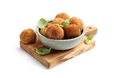Photo of Delicious fried croquette balls with basil in bowl isolated on white