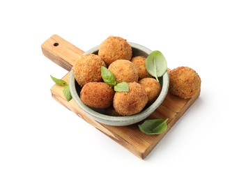 Photo of Delicious fried croquette balls with basil in bowl isolated on white