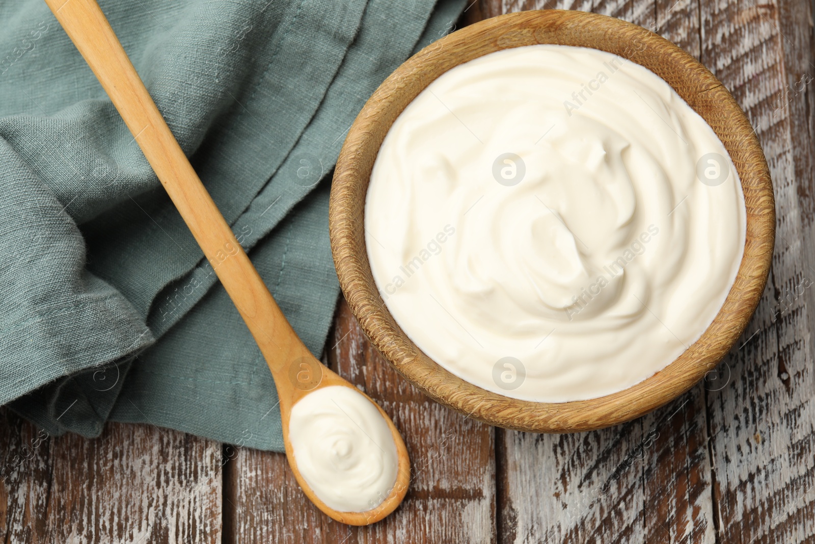 Tasty sour cream on wooden table, flat lay Photo of Tasty sour cream on wooden table, flat lay