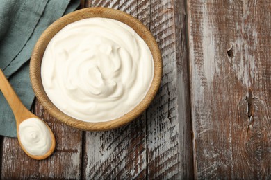 Photo of Tasty sour cream on wooden table, flat lay. Space for text