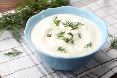 Photo of Tasty sour cream with dill on table, closeup