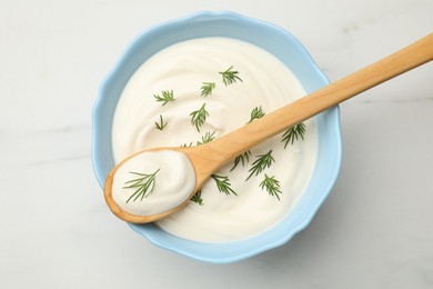 Photo of Tasty sour cream with dill on white table, top view