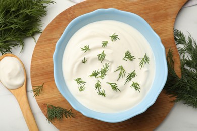 Photo of Tasty sour cream and dill on white table, flat lay