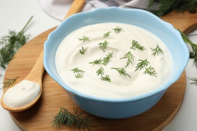 Photo of Tasty sour cream with dill on white table, closeup